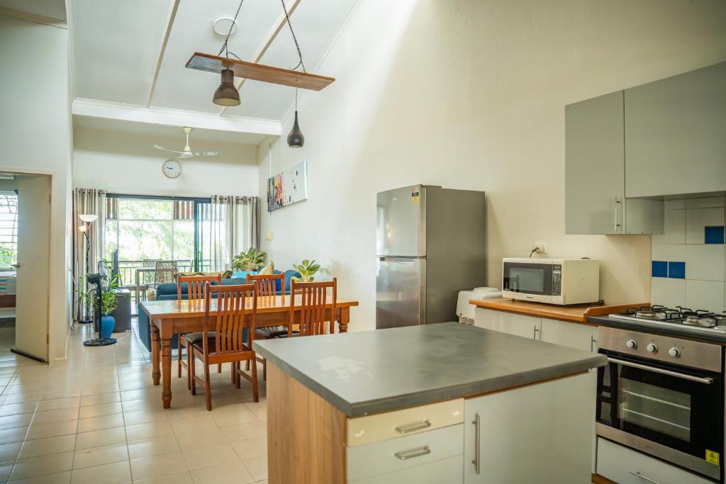 a kitchen with a table and a dining room at seaview apartment in Honiara