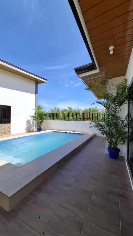 a swimming pool in the backyard of a house at Isla Del Mar Villas in Panglao Island