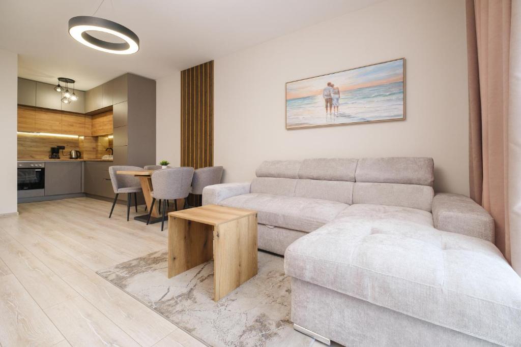 a living room with a couch and a table at River View 1-Bedroom Apartment in Plovdiv