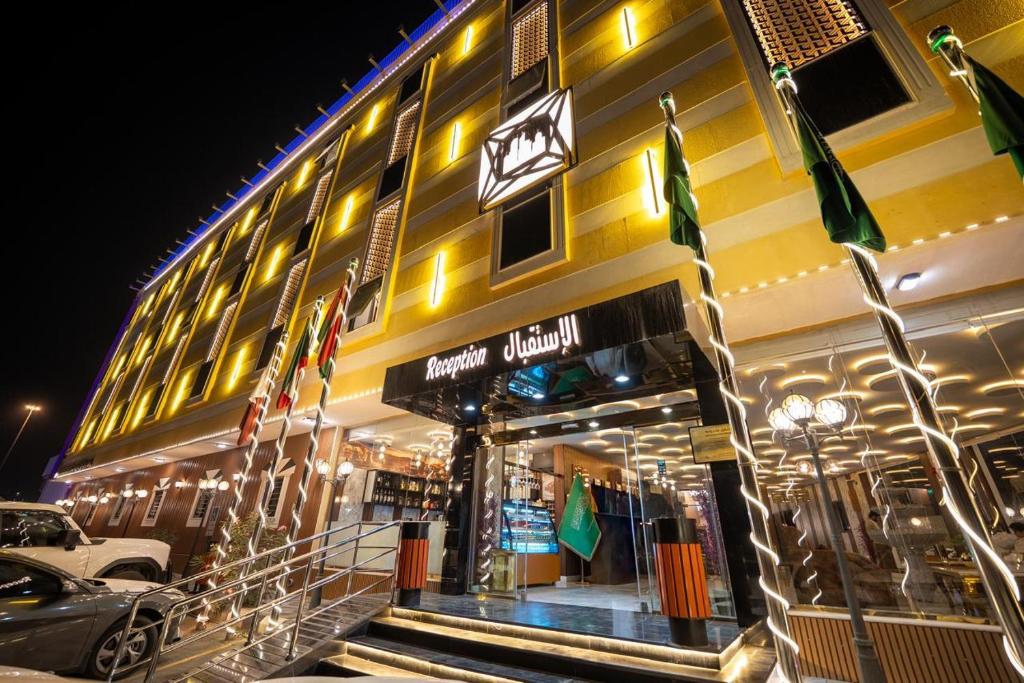 a building with flags in front of a store at راحتي هنا للشقق المخدومة in Riyadh