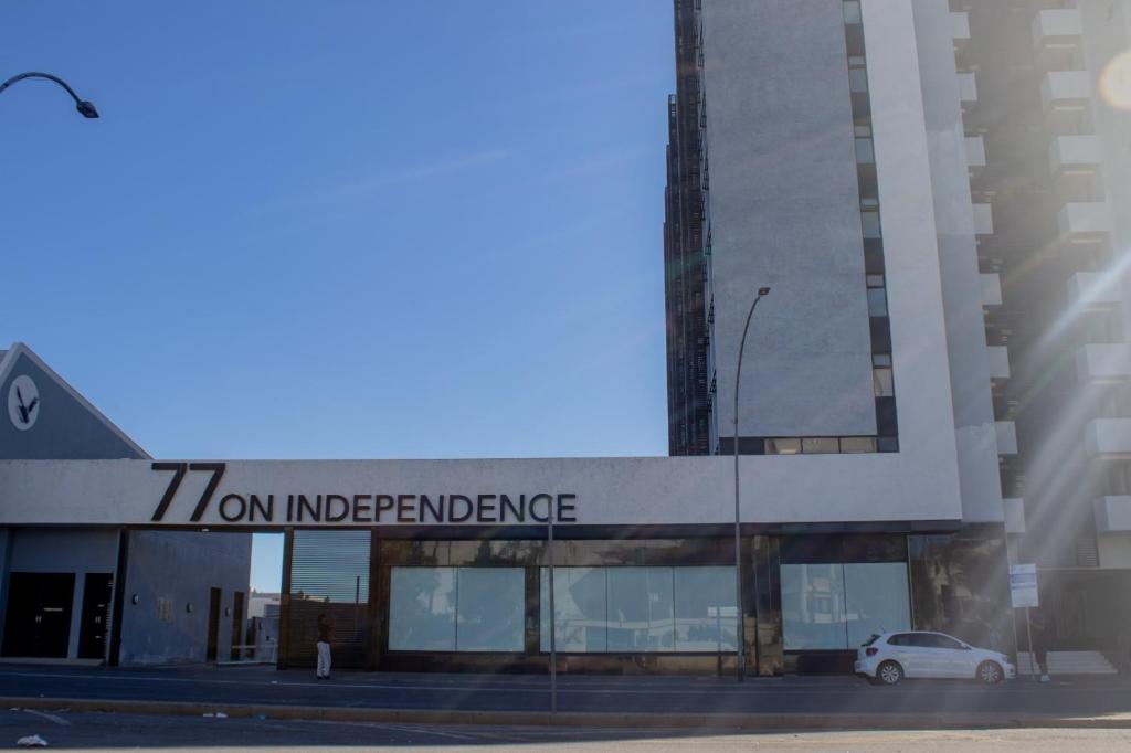 a car is parked in front of a building at 77 ON Independence Avenue in Windhoek