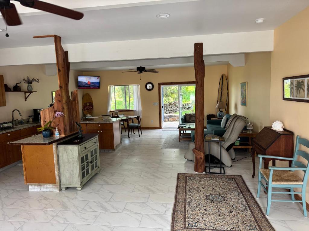 a living room with a kitchen and a dining room at Silver Dollar Tree in Kealakekua