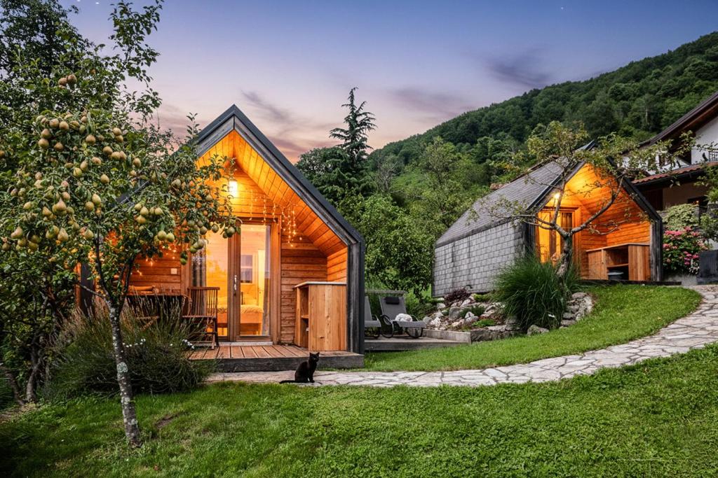 a small house in the middle of a yard at Glamping Kranjc in Kobarid