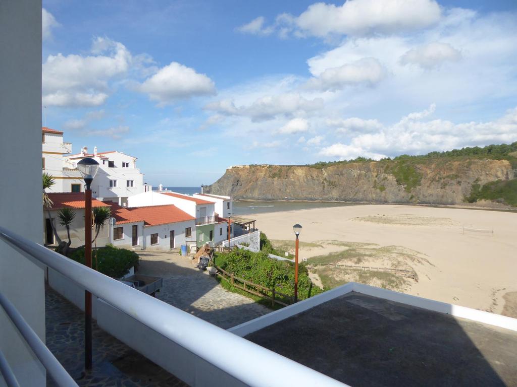 a view of the beach from a balcony at Ponta Branca Beach House in Odeceixe