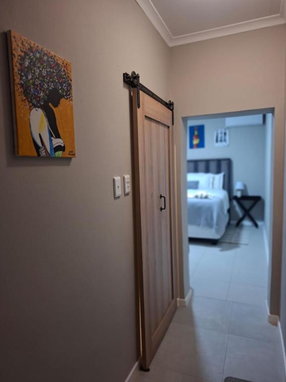 a room with a door leading to a bedroom at House Sawubona in Kroonstad