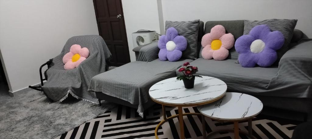 a living room with three stuffed animals on a couch at Lakefront Homestay in Taiping