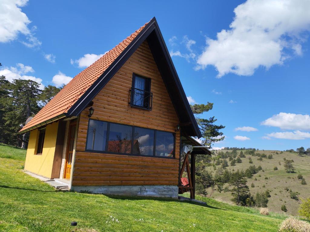 a cabin on a hill with a large window at Kod Gruja in Ribnica