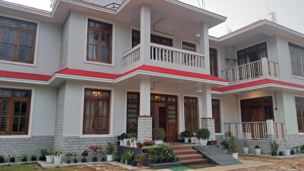 a house with two floors and a balcony at Red Cherry Homestay, Nokdara in Lava