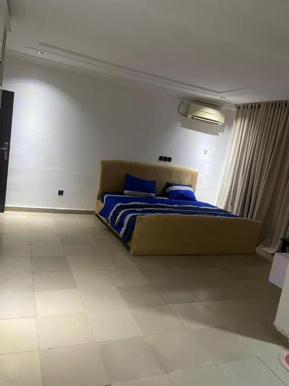 a bedroom with a bed with blue pillows on it at Haven Residence in Rubuchi