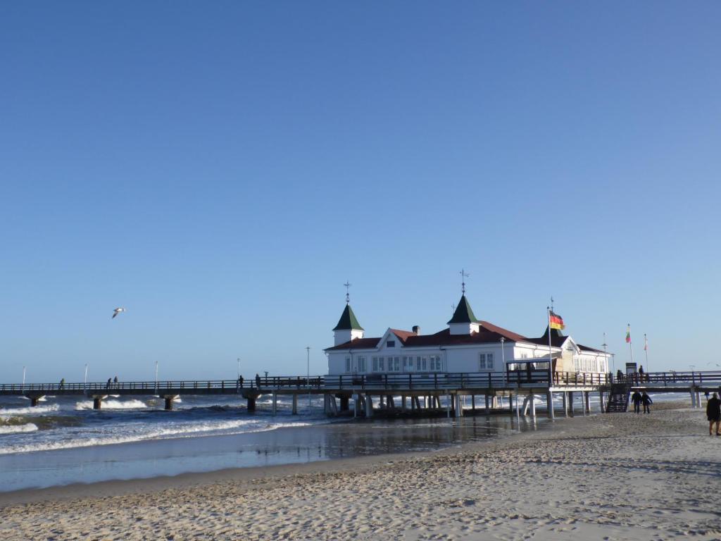 a pier on the beach next to the ocean at Haus Sandra in Ahlbeck