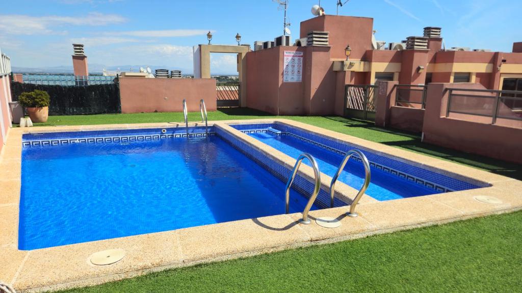 a swimming pool on the roof of a house at Apartment Segura 2BD in Rojales