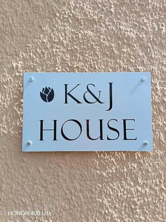 a sign that saysk i house on a wall at K&J House in Didyma