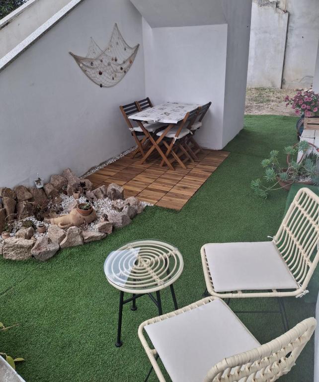 a patio with two chairs and a table and a table and chairs at Appartamento Valle in Valledoria