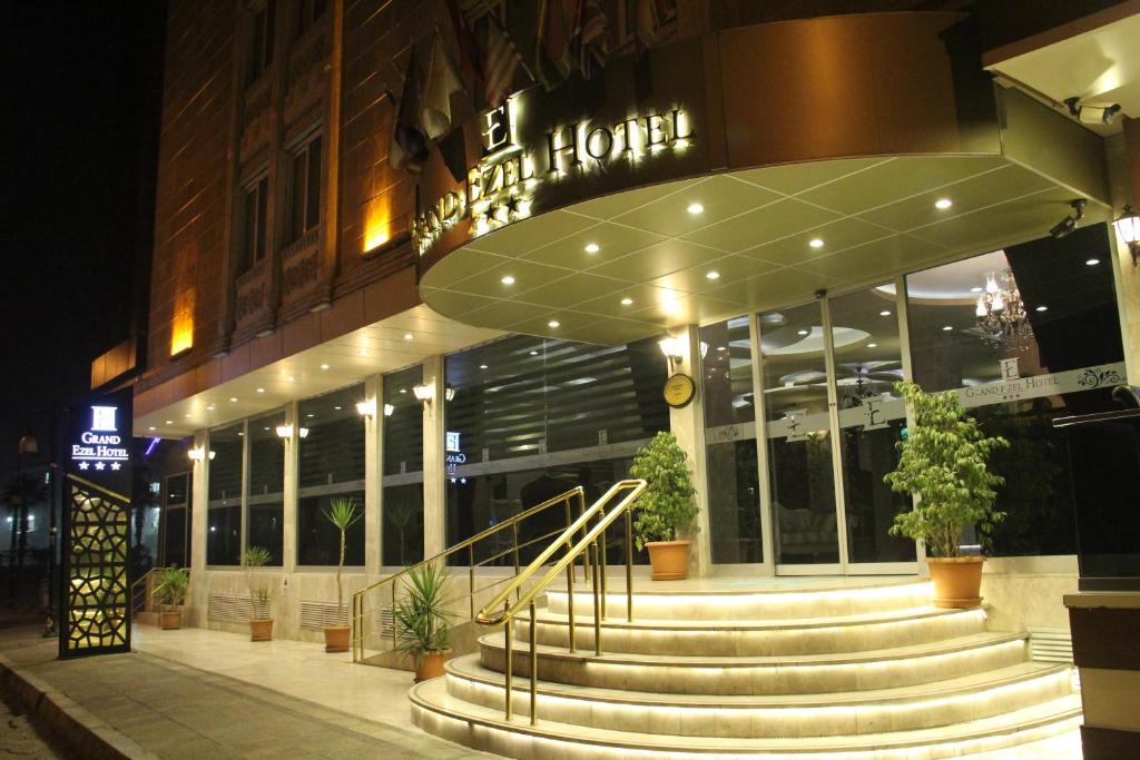 a hotel with stairs in front of a building at night at Grand Ezel Hotel in Mersin