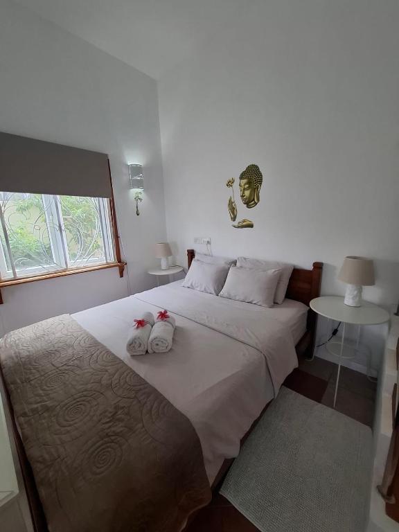 a bedroom with a bed with two stuffed animals on it at Jay&Kay CosyRoom FlicEnFlac in Flic-en-Flac