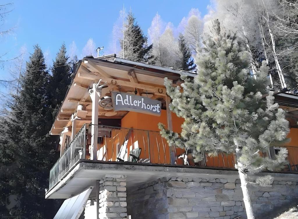 a building with a sign that reads aladdin lodge at Chalet Adlerhorst am Großglockner in Heiligenblut