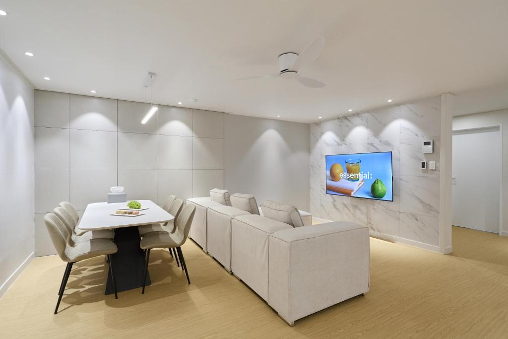 a living room with a white couch and a table at soul stay in Busan