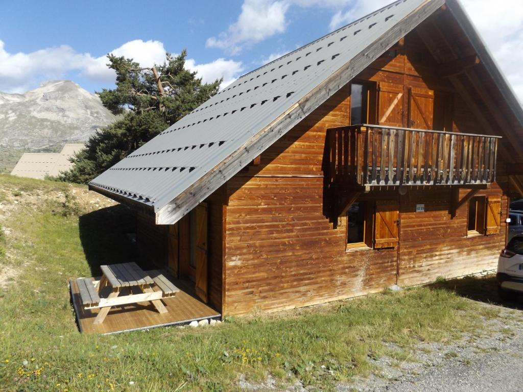 a log cabin with a porch and a balcony at Chalet Bastilor in La Joue du Loup