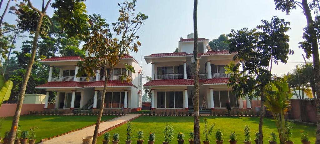 a large house with trees in front of it at Prantik Retreat in Bāgnān