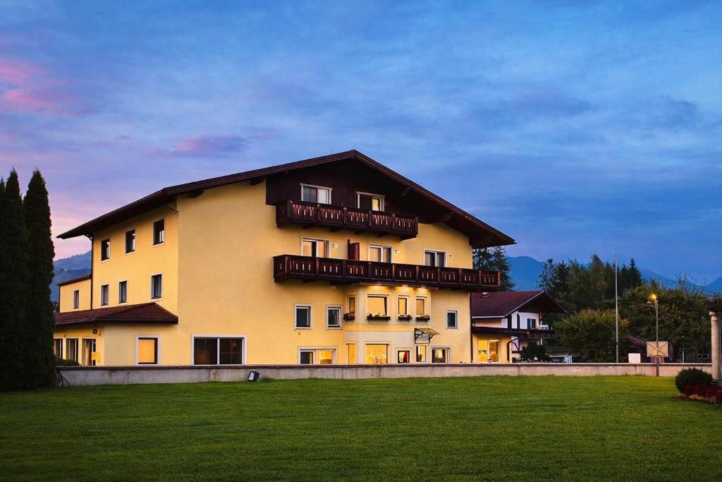 a large yellow building with balconies on top of it at Boutique Hotel Lainbach in Reutte