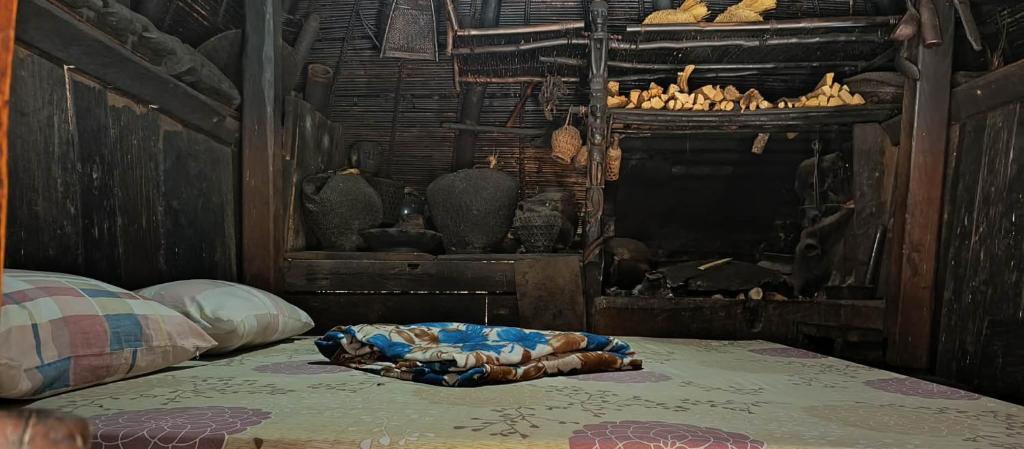 a bed with a blanket on top of it at Ramon's Homestay in Banga-an