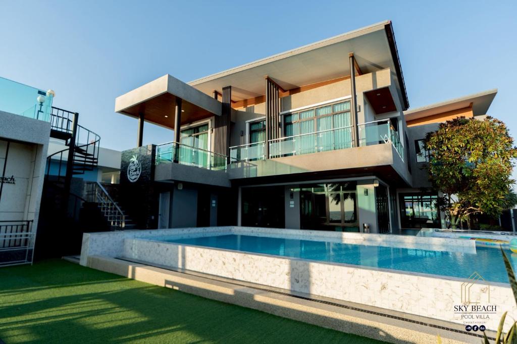 a house with a swimming pool in front of it at Sky Beach Pool Villa Chanthaburi 1 in Laem Sing