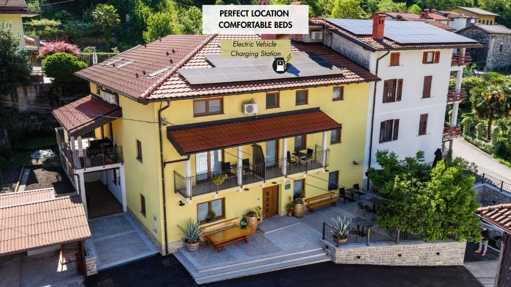 an aerial view of a yellow house with a roof at Apartmaji Tinta in Kanal