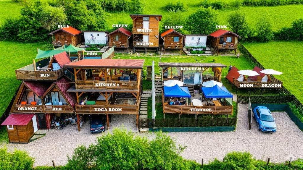 an aerial view of a house with cars parked outside at Bosnian Pyramid Glamping in Visoko