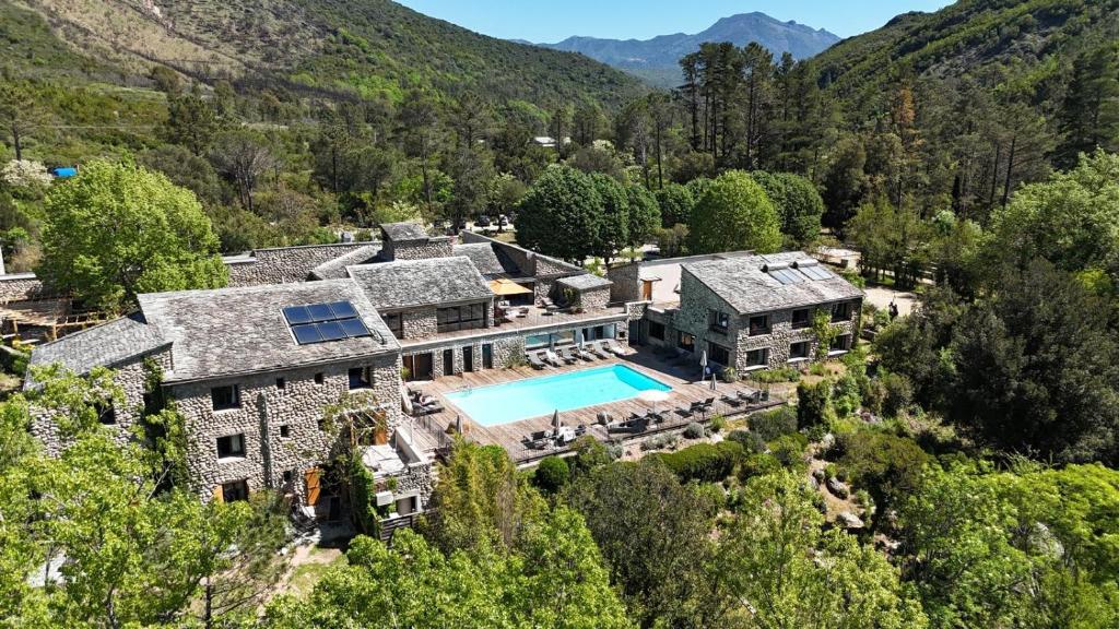 an aerial view of a house with a swimming pool at Hotel E Caselle - Demeures & Châteaux in Venaco