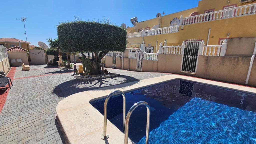 a swimming pool in front of a building at CASA LUTHI Costa Blanca in Orihuela Costa