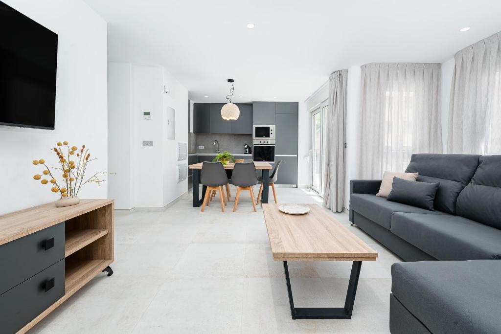 a living room with a couch and a table at Sunrise Center Suites in Torrevieja