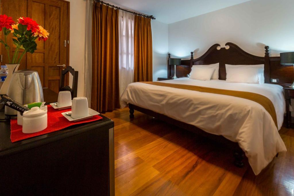 Postel nebo postele na pokoji v ubytování Illa Hotel