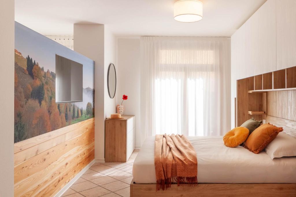 a bedroom with a bed and a large window at Alle Porte in Vittorio Veneto