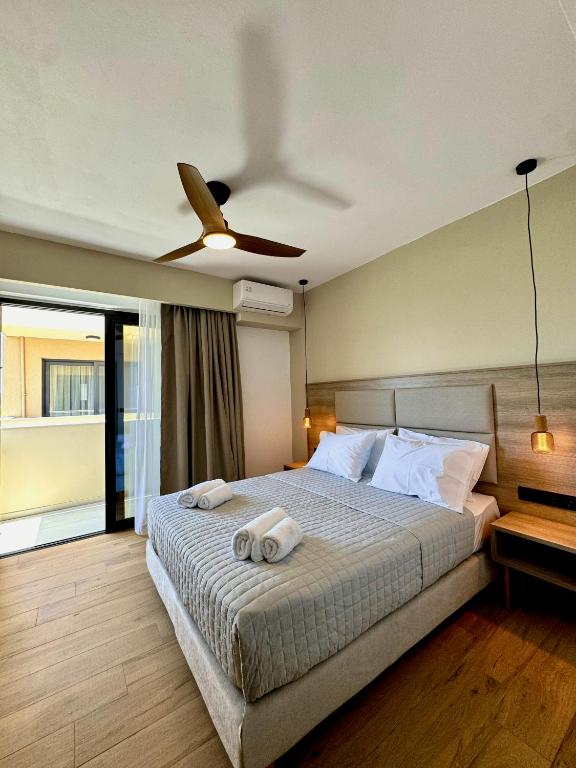 a bedroom with a bed with two towels on it at Celene Luxury Plakias in Plakias