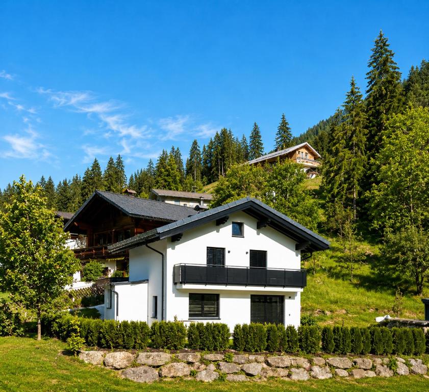 a white house with a black roof at My Appartements in Untertauern