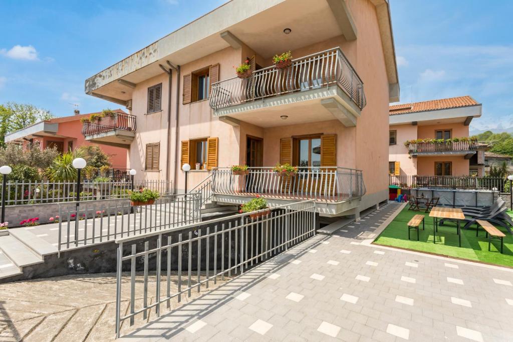 an apartment building with balconies and a patio at Il Vulcano di Milo in Milo