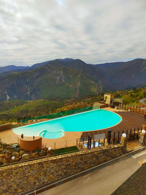 an overhead view of a swimming pool with mountains in the background at Piscina, Spa e Mare a Casa Torretta in collina in Magliolo