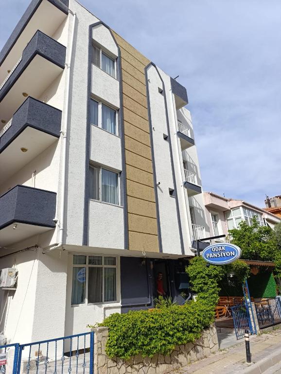 a building with a sign in front of it at Odak Pansiyon in Çanakkale