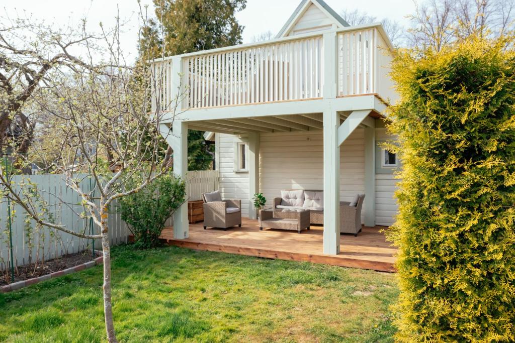 a house with a deck and a patio at Cabin Guesthouse with free parking in Pärnu