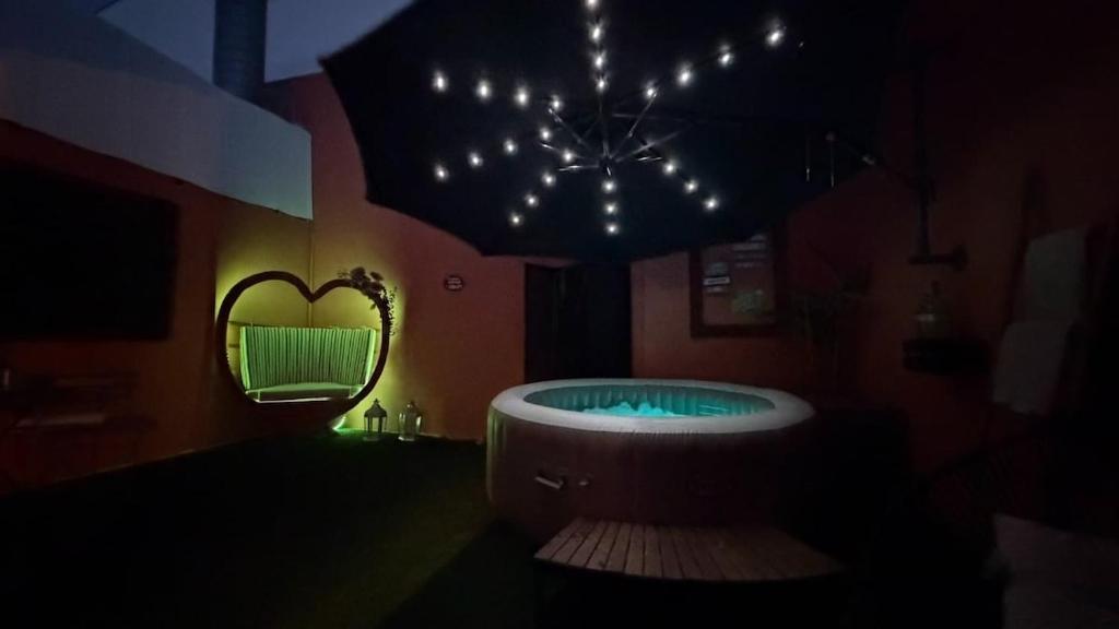 a bathroom with a tub and a heart shaped mirror at Dejavu Terrace Setúbal in Setúbal