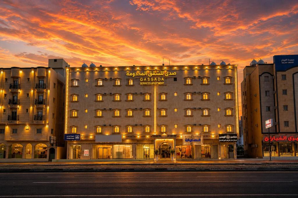 a hotel building with a sunset in the background at صدي للشقق المخدومة in Khamis Mushayt