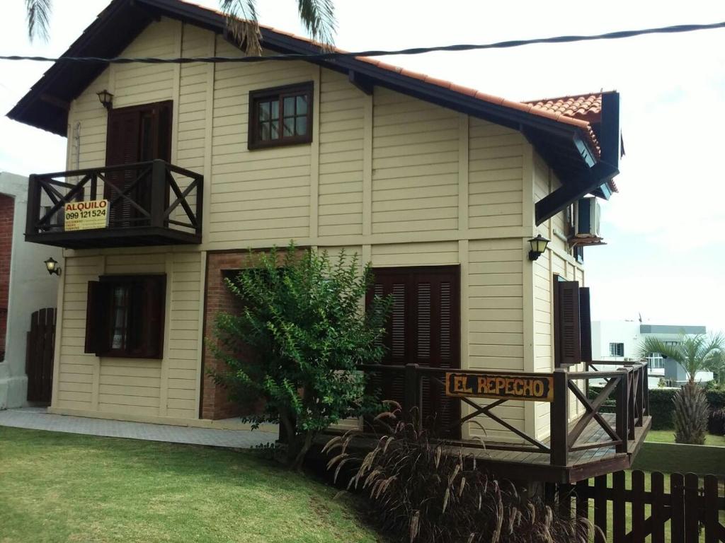 a house with a sign in front of it at El Repecho in Piriápolis