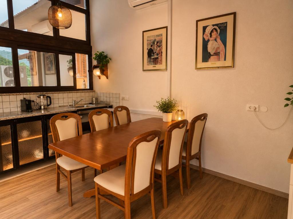 a dining room with a wooden table and chairs at Nortra apartment in Tolmin