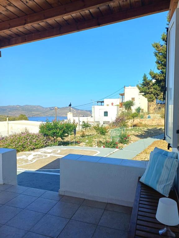 a view from a patio with a bench and a view at Georgia Rooms Milos in Plaka Milou