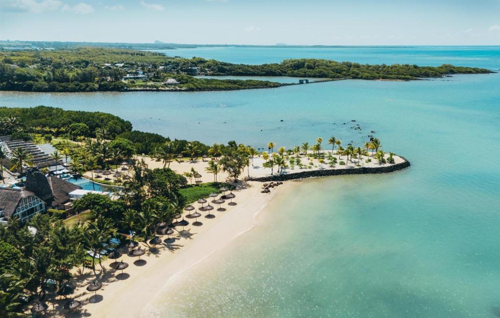 an aerial view of a beach with palm trees and the ocean at Radisson Blu Azuri Resort & Spa in Roches Noires