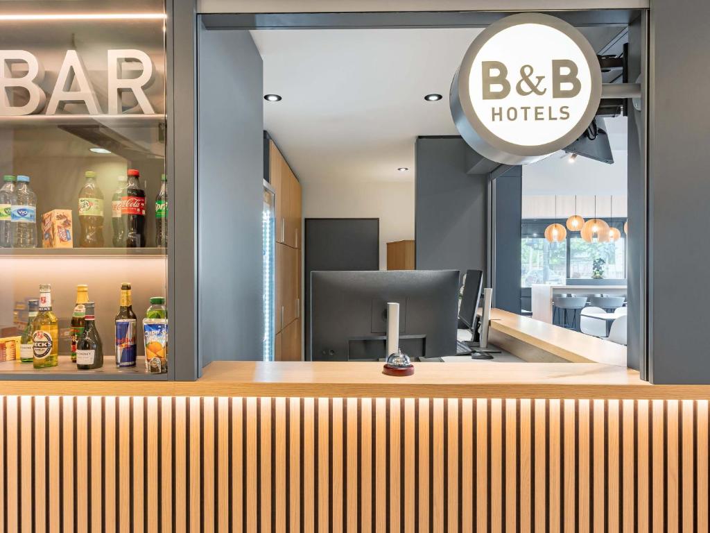 a bar at a restaurant with a sign on it at B&B HOTEL Saarbrücken-Ost in Saarbrücken