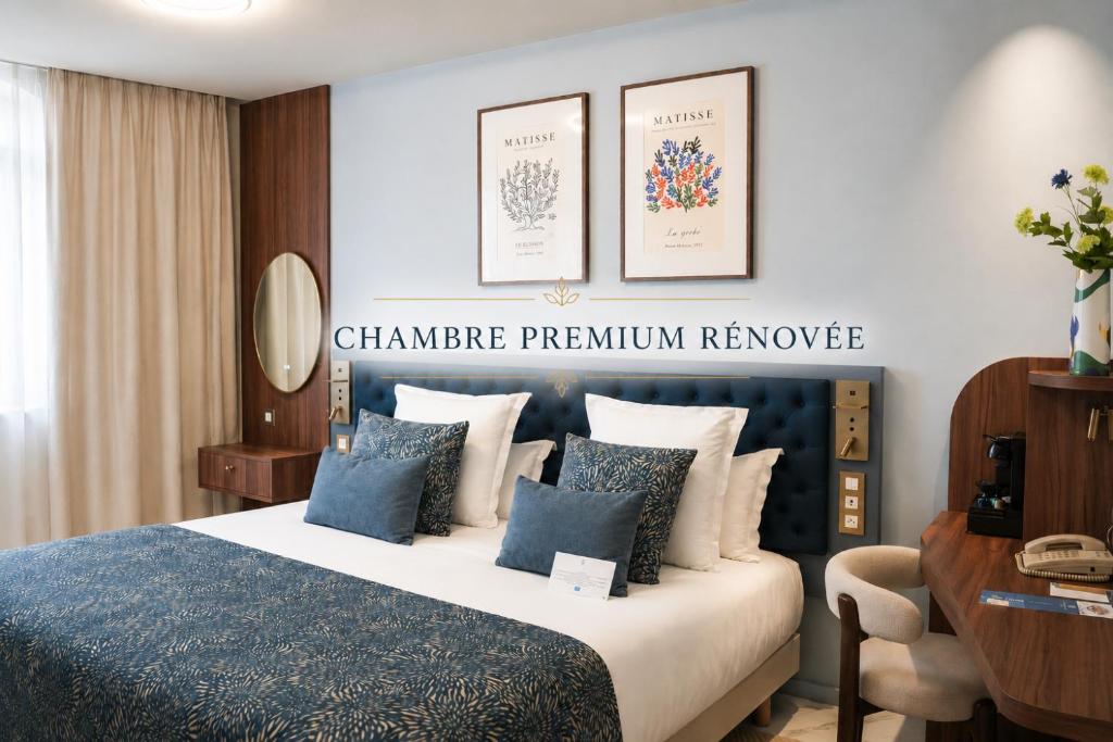 a hotel room with a bed and a desk at Hotel Beau Rivage in Nice