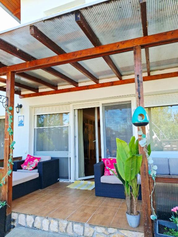 a patio with two couches and a wooden pergola at Bella Garden in Balatonszárszó