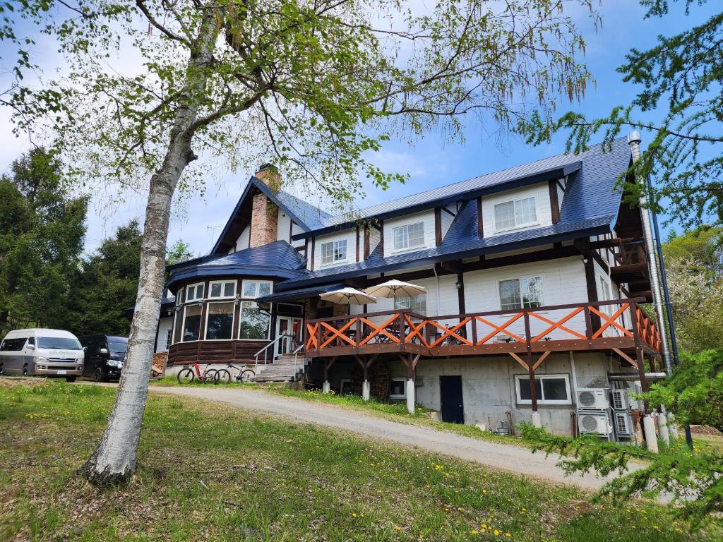 a large house with a blue roof at Lodge Clubman in Hachimantai