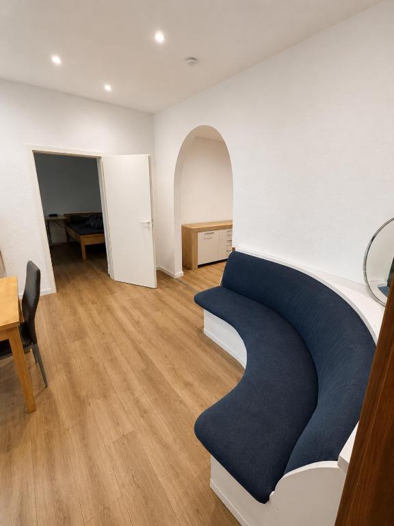 a living room with a blue couch and a table at Apartment Rahden in Rahden
